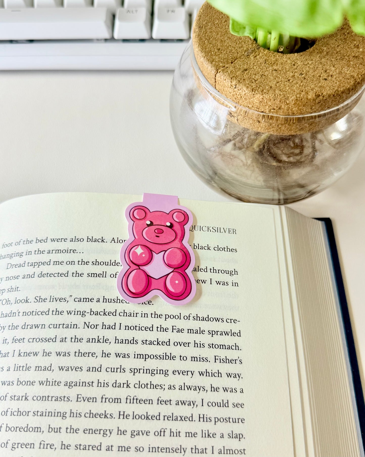Red & Pink Gummy Bear Magnetic Bookmarks. Hot pink gummy bear magnetic bookmark set in book showcasing how it can be used.