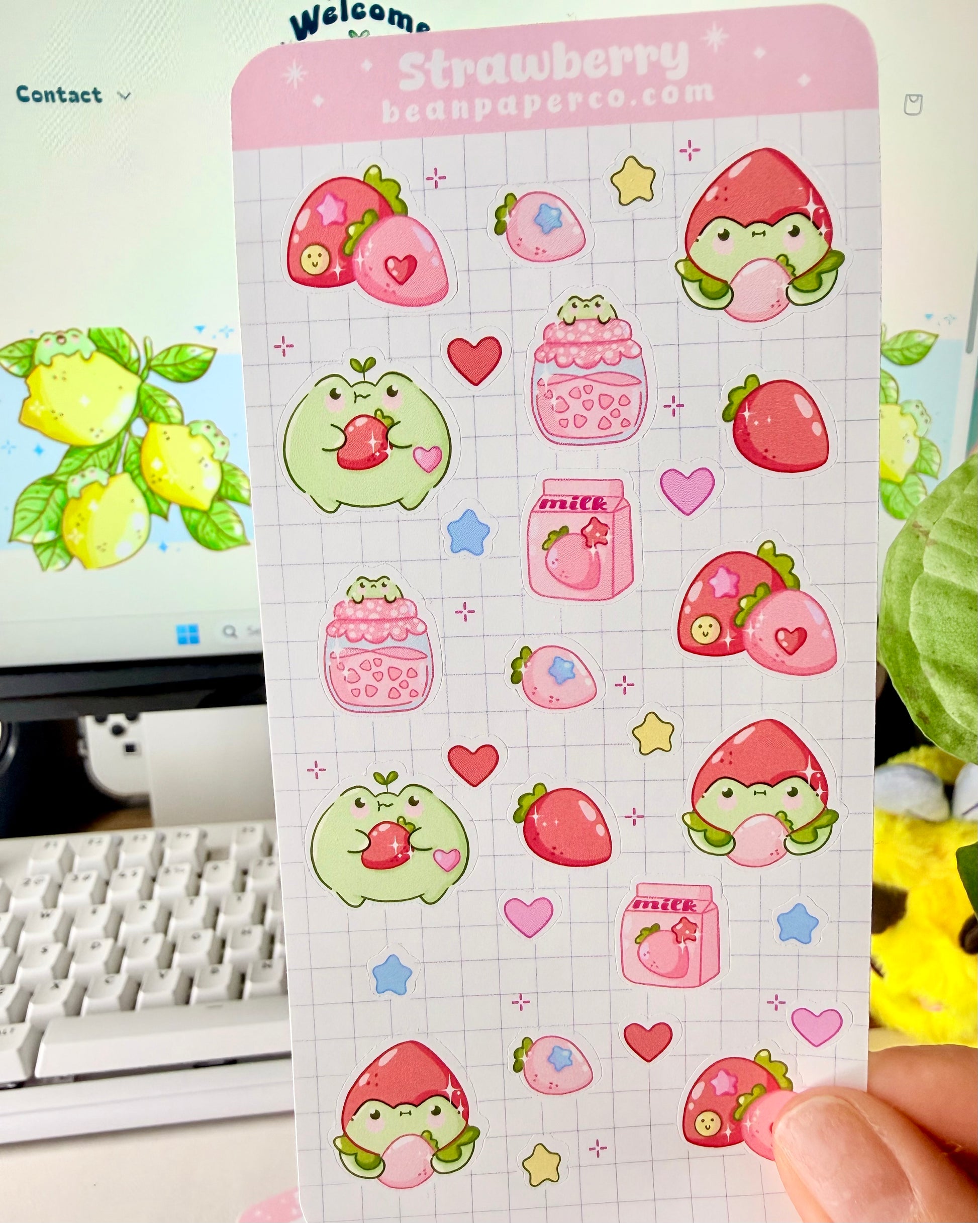 Strawberry Fruit Frog Sticker Sheet featuring cute green frogs, strawberries, strawberry jam jars, milk cartons, hearts, and star accents.