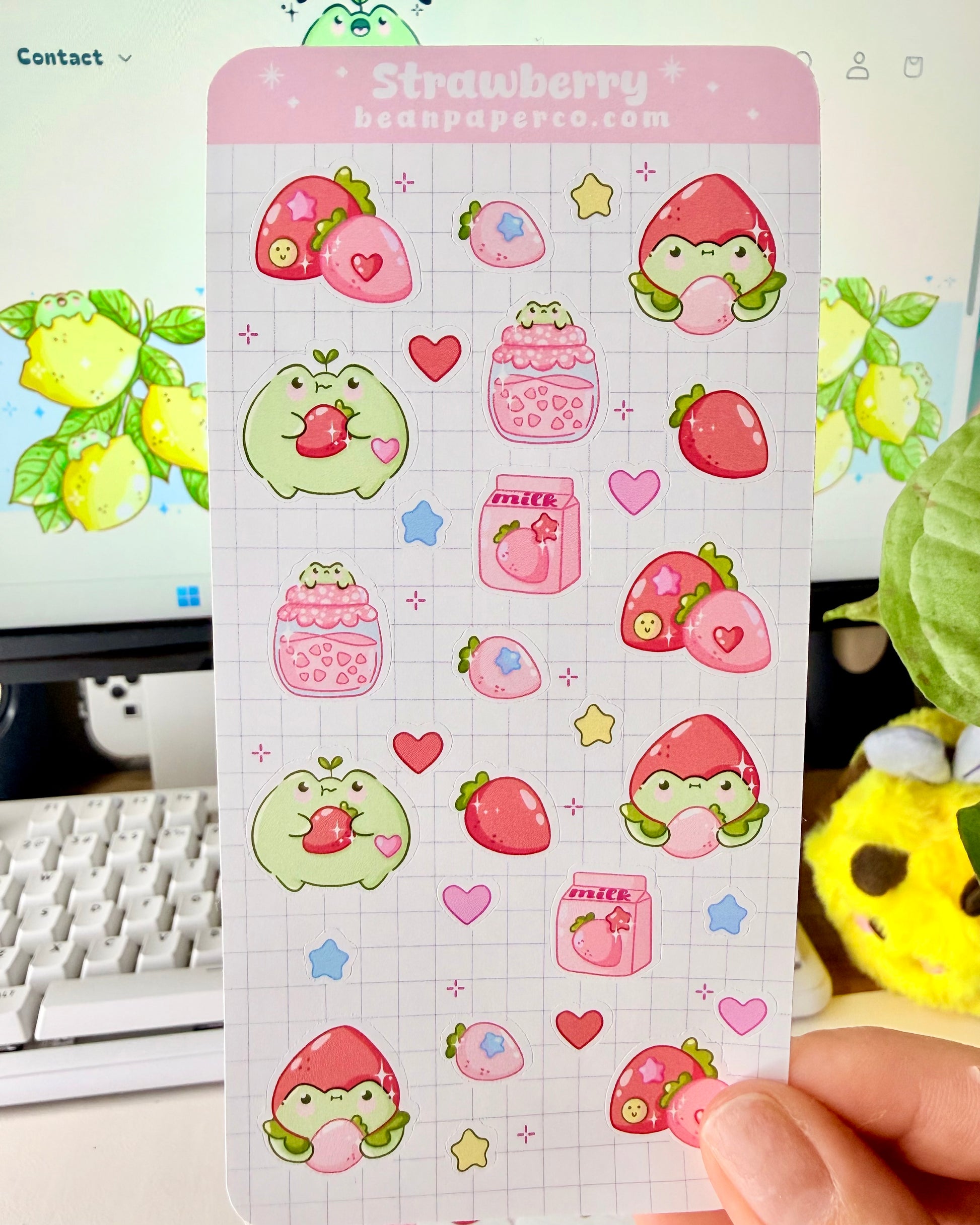 Strawberry Fruit Frog Sticker Sheet featuring cute green frogs, strawberries, strawberry jam jars, milk cartons, hearts, and star accents.