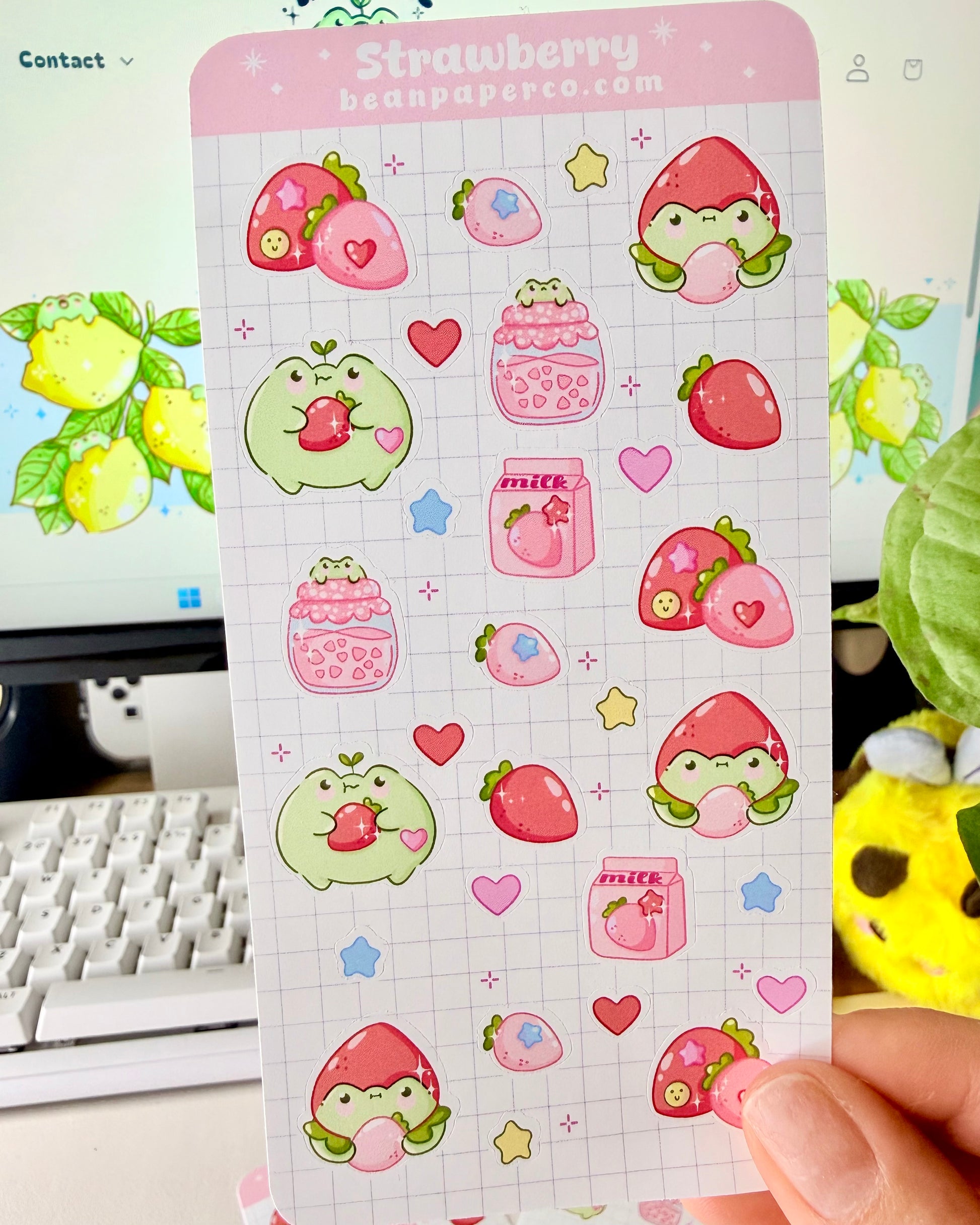 Strawberry Fruit Frog Sticker Sheet featuring cute green frogs, strawberries, strawberry jam jars, milk cartons, hearts, and star accents.