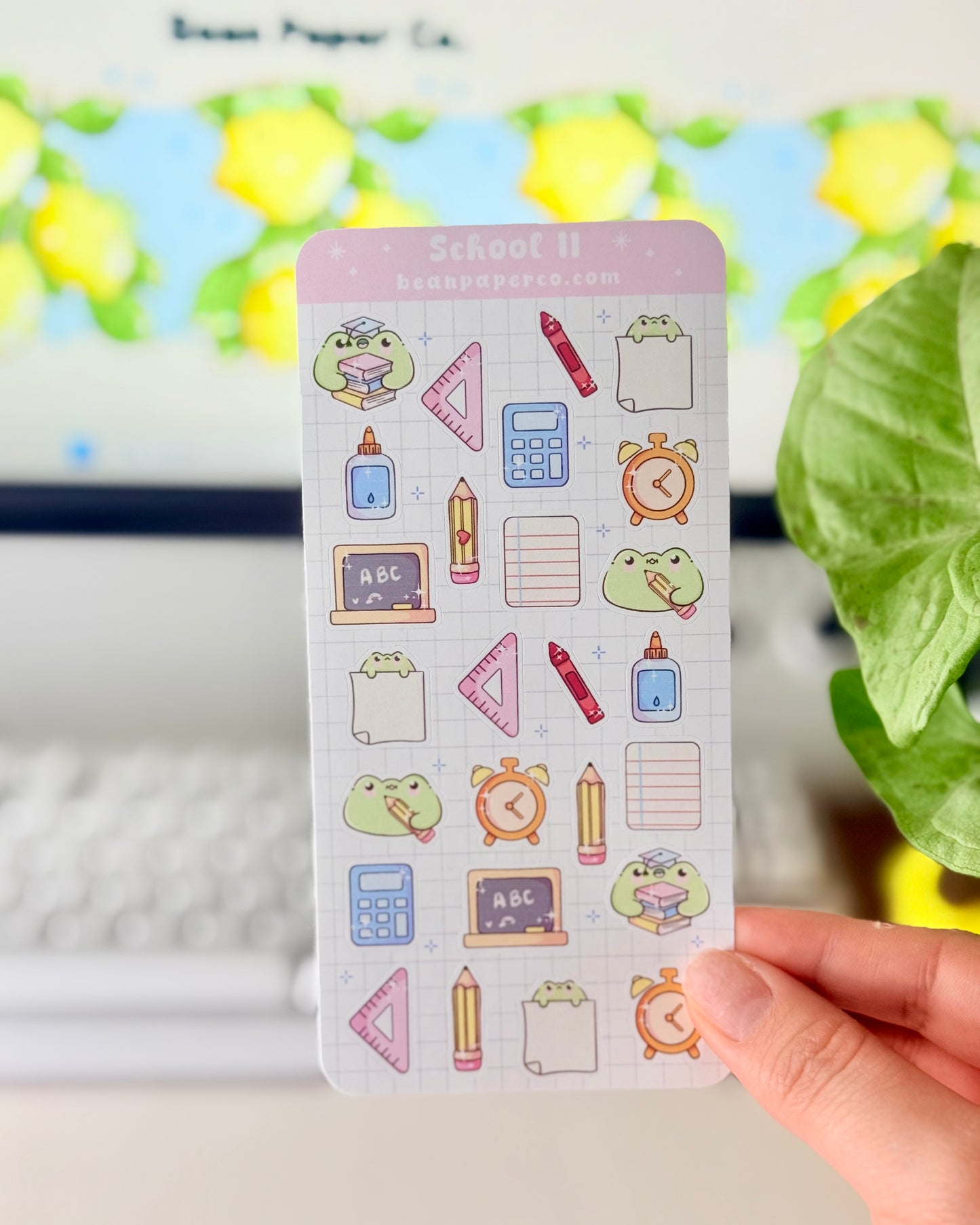 Cute School Frog Sticker Sheet featuring frogs with books and graduation caps, calculators, glue bottles, alarm clocks, chalkboards, and triangle rulers.