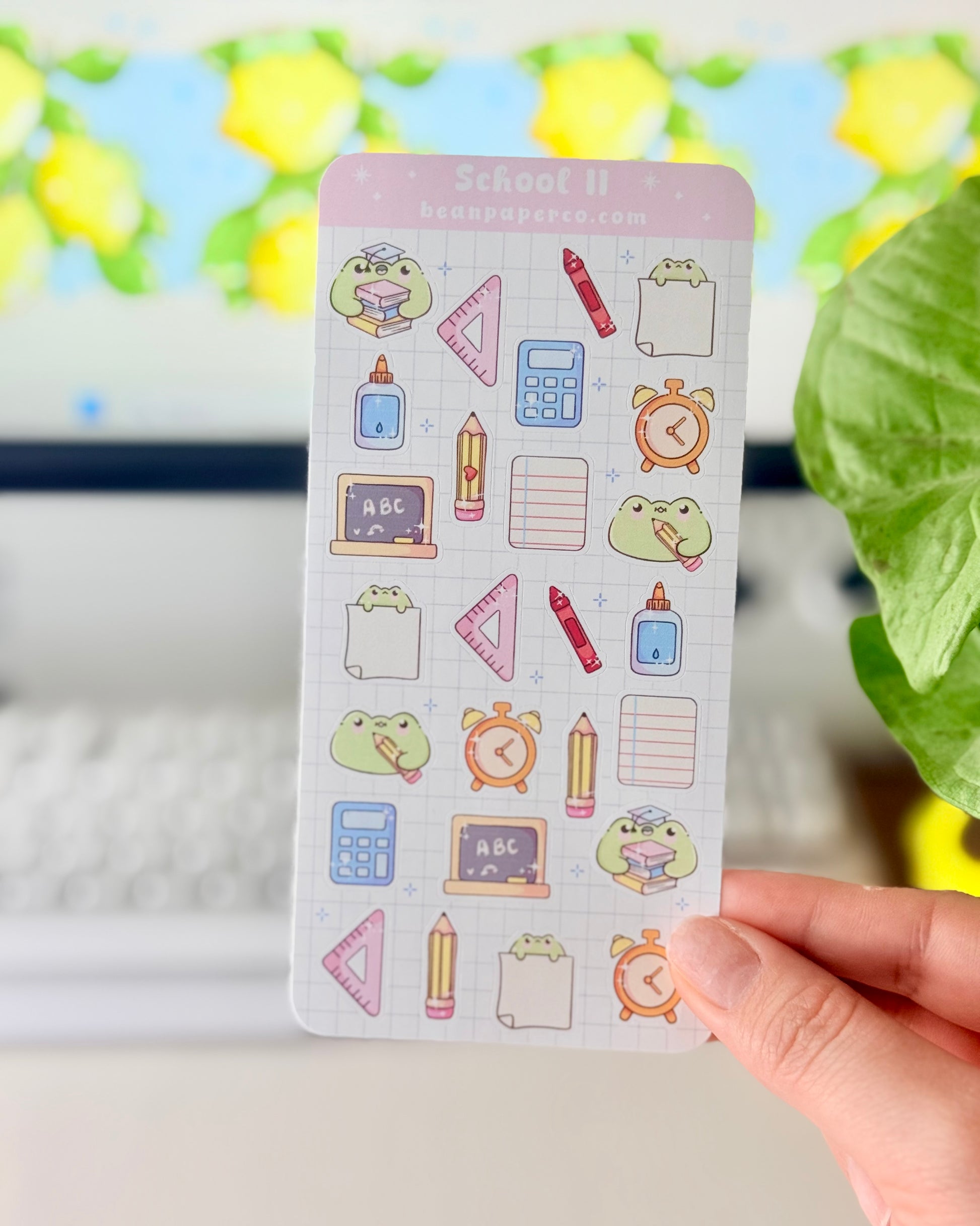 Cute School Frog Sticker Sheet featuring frogs with books and graduation caps, calculators, glue bottles, alarm clocks, chalkboards, and triangle rulers.