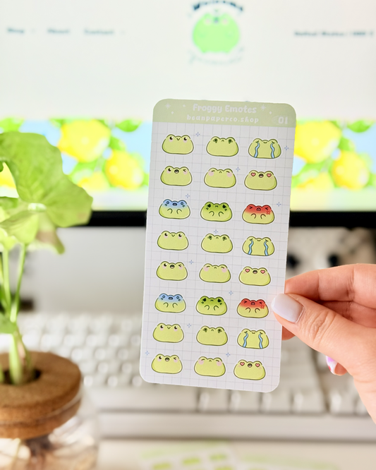 Cute Frog Emote Planner Stickers featuring cute green frog faces with different expressions including happy, blushing, crying, angry, and heart eyes.