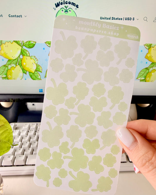 Cute March Clover Sticker Sheet held by hand featuring green ombre clovers.