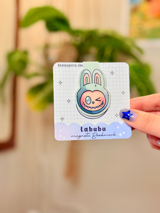Labubu The Monsters Magnetic Bookmark design displayed in a hand with vibrant colors and a cute bunny character.