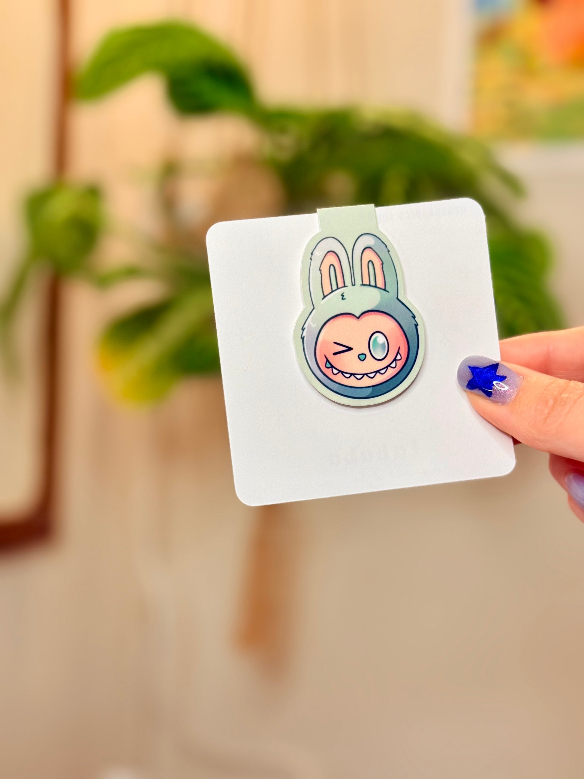 Labubu The Monsters Magnetic Bookmark showcased with a cute bunny design in a hand, perfect for marking pages.