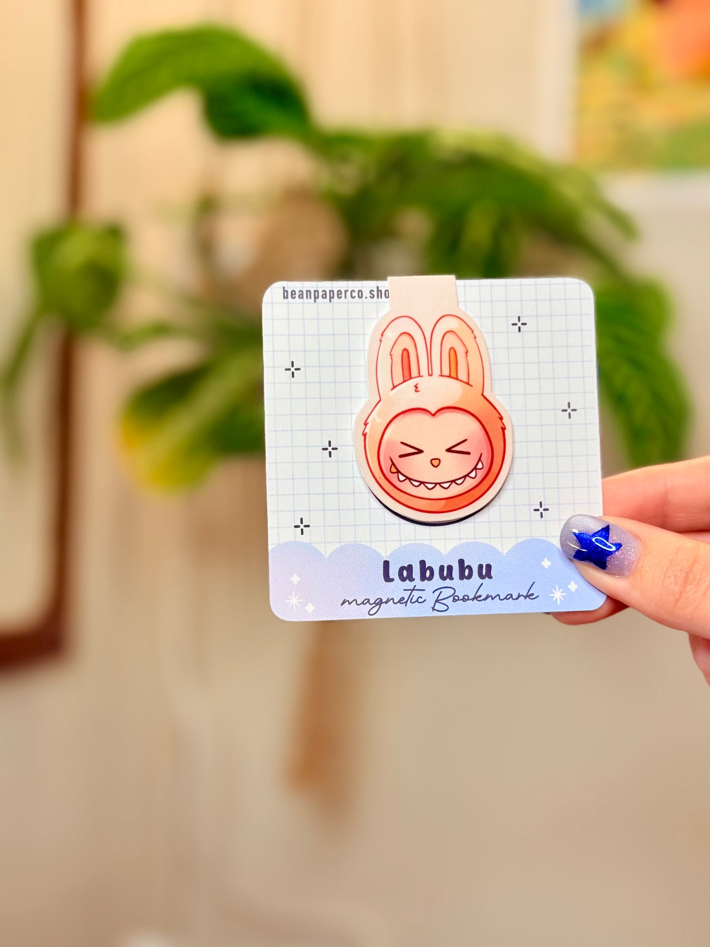 Labubu The Monsters Magnetic Bookmark design displayed in a hand with vibrant colors and a cute bunny character.