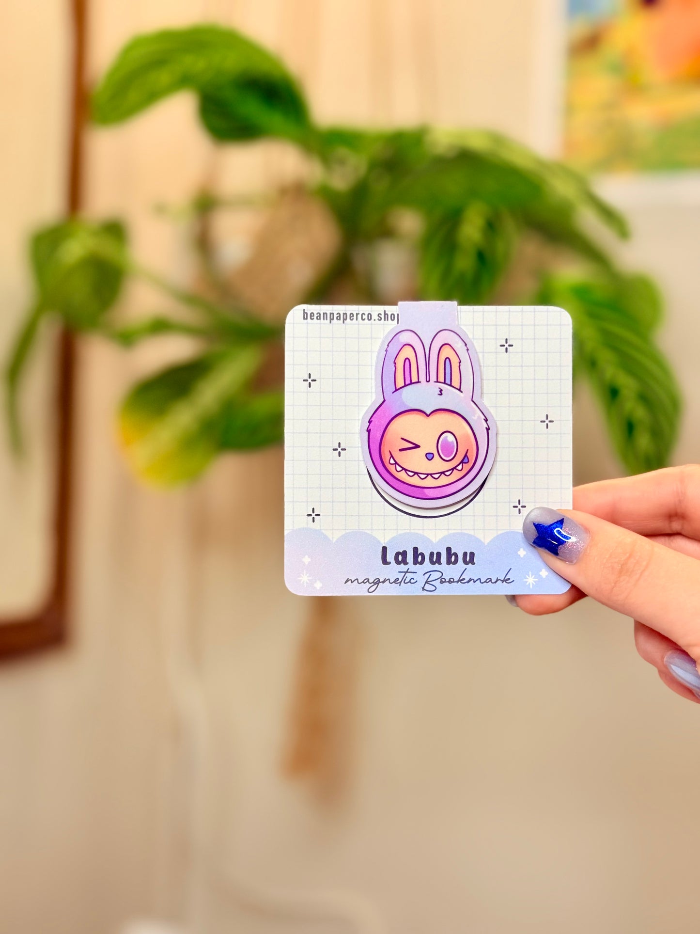 Labubu The Monsters Magnetic Bookmark design displayed in a hand with vibrant colors and a cute bunny character.