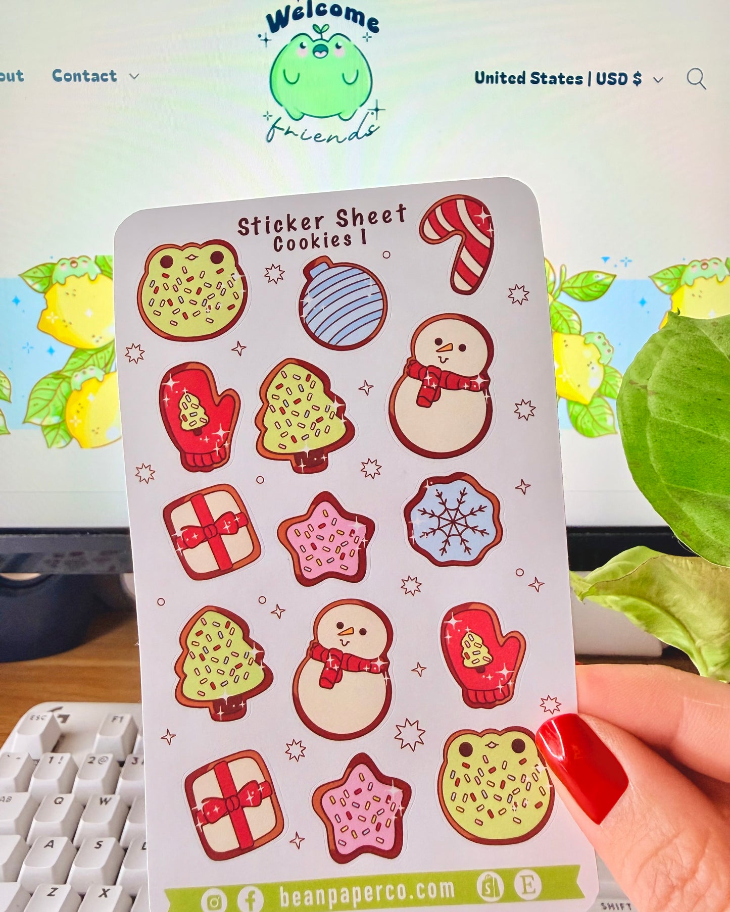 “Cookies-themed winter sticker sheet featuring frog-shaped cookies, candy canes, snowmen, mittens, ornaments, and gift boxes.”