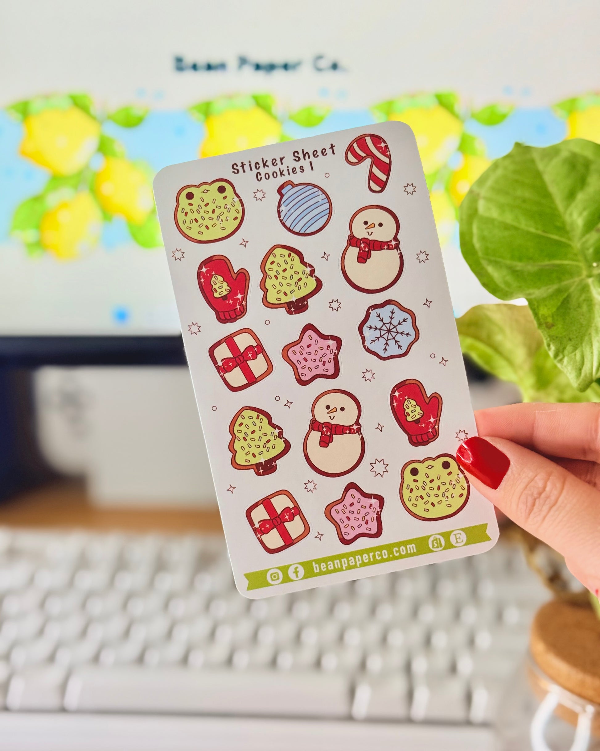 “Cookies-themed winter sticker sheet featuring frog-shaped cookies, candy canes, snowmen, mittens, ornaments, and gift boxes.”