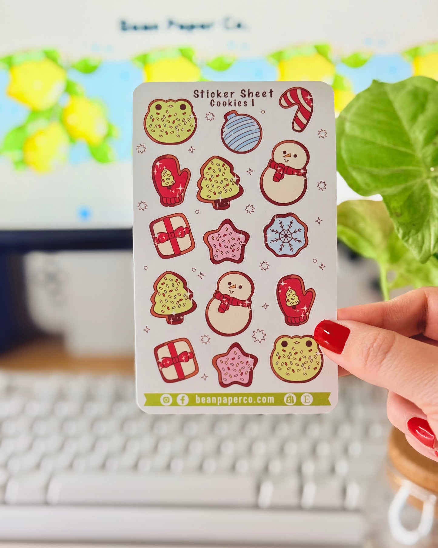 “Cookies-themed winter sticker sheet featuring frog-shaped cookies, candy canes, snowmen, mittens, ornaments, and gift boxes.”