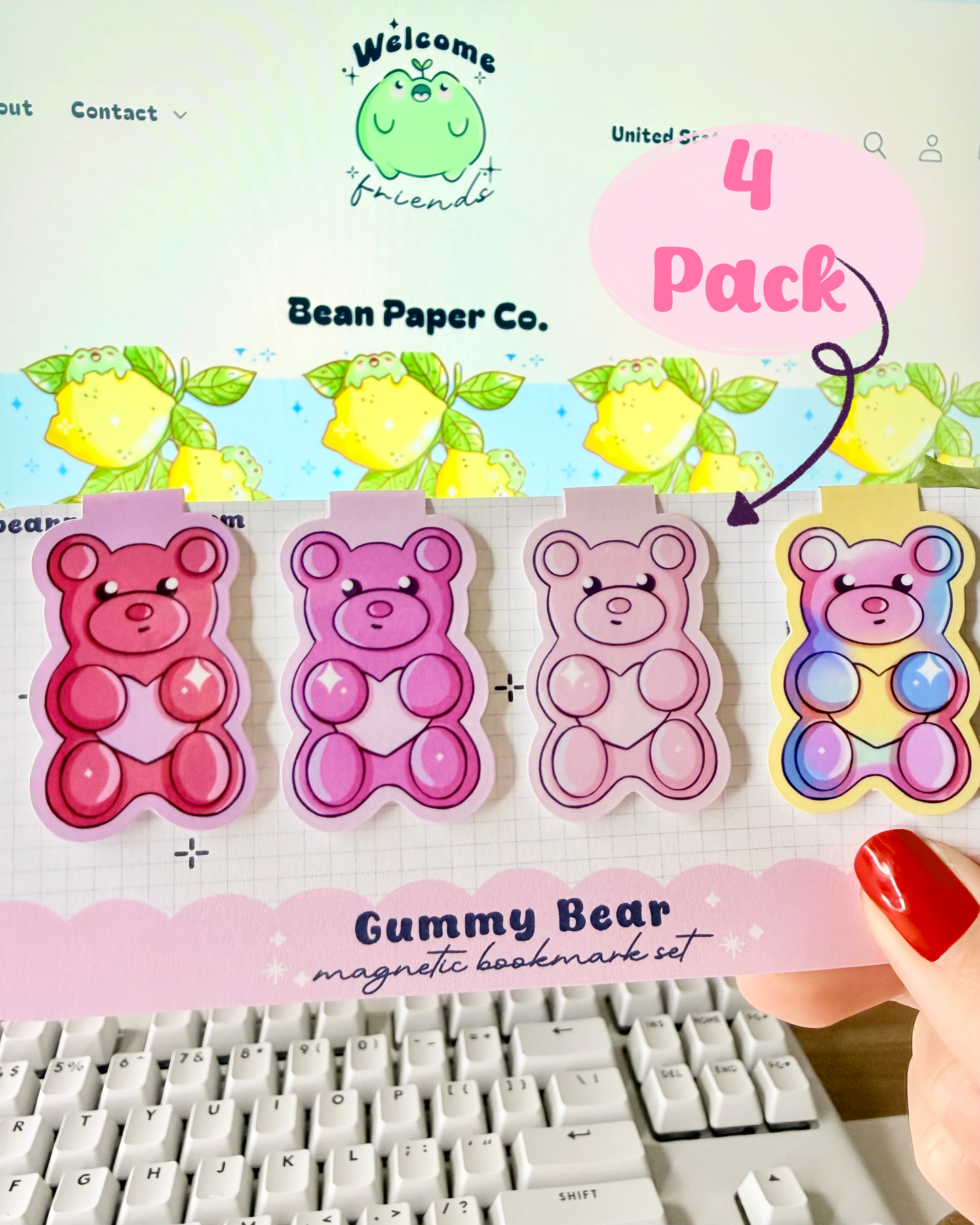 Red & Pink Gummy Bear Magnetic Bookmarks. Set of 4 Magnetic bookmarks held in hand against blurred Bean Paper Co. website background.
